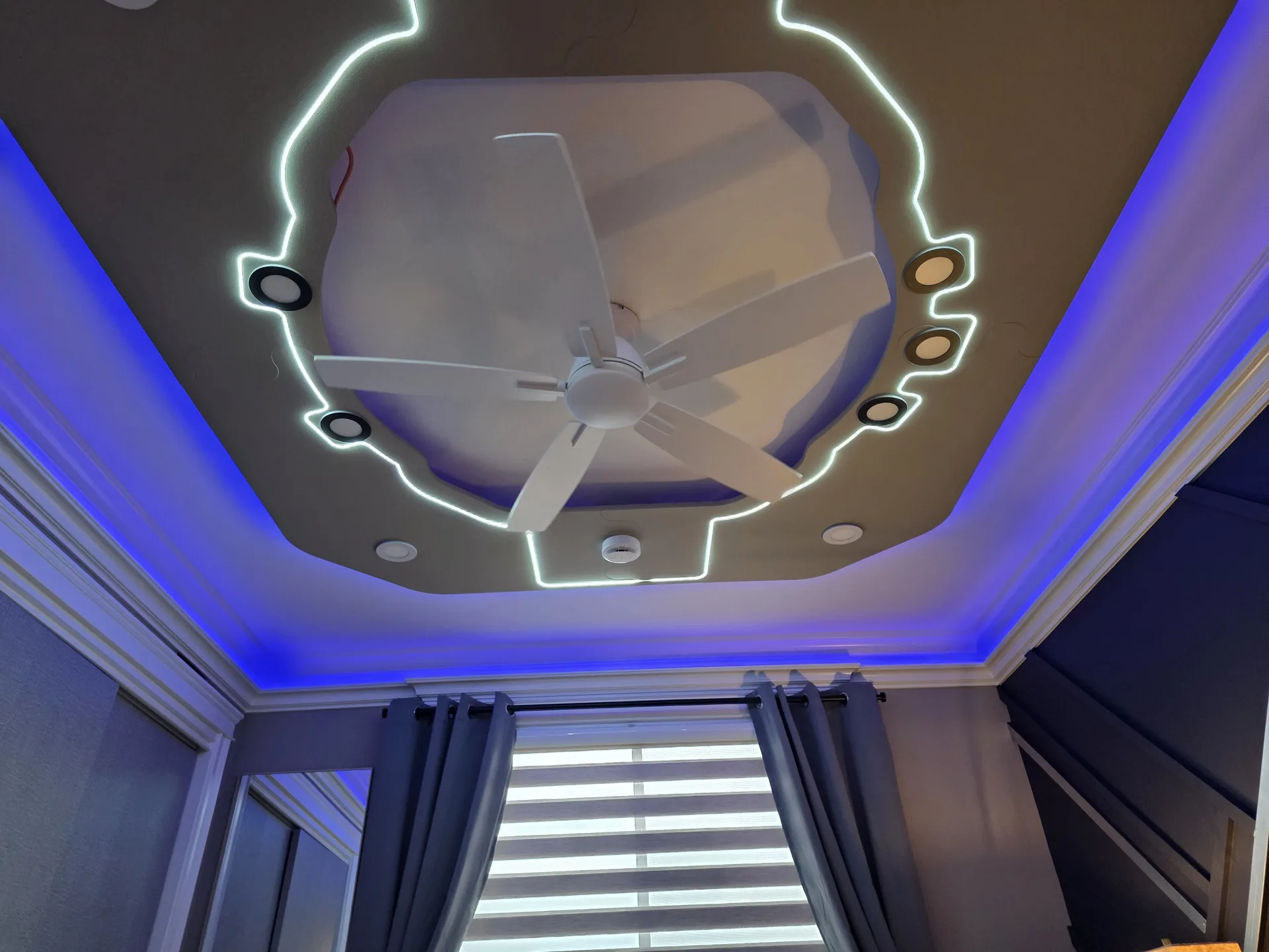Bedroom with hexagonal LED ceiling detail