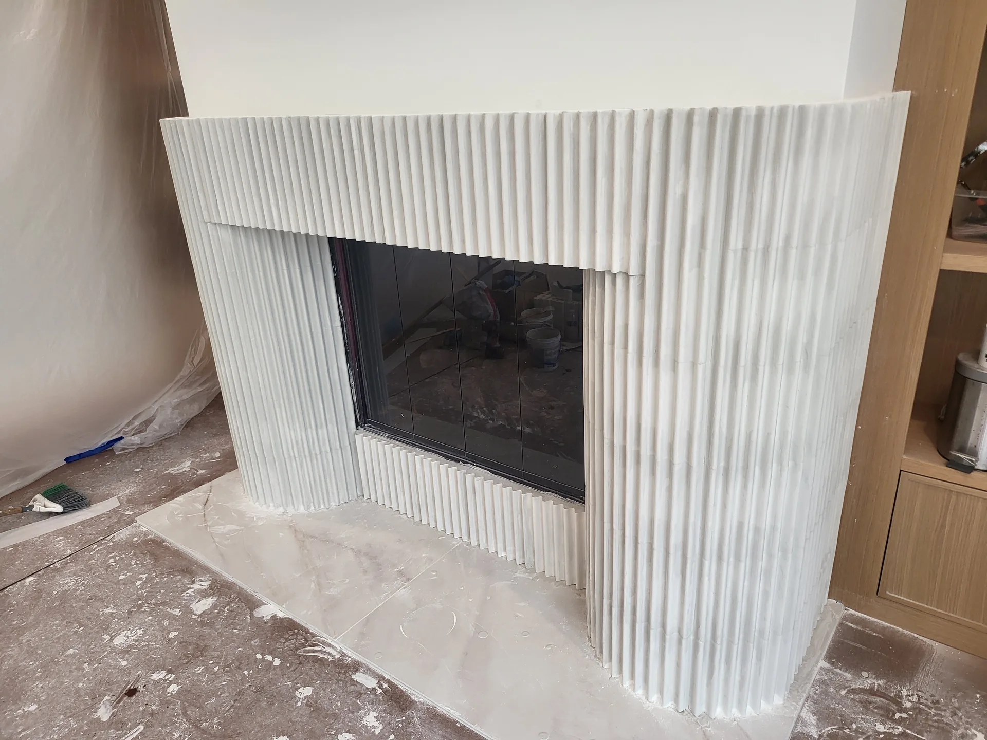 Curved fluted fireplace mantel detail