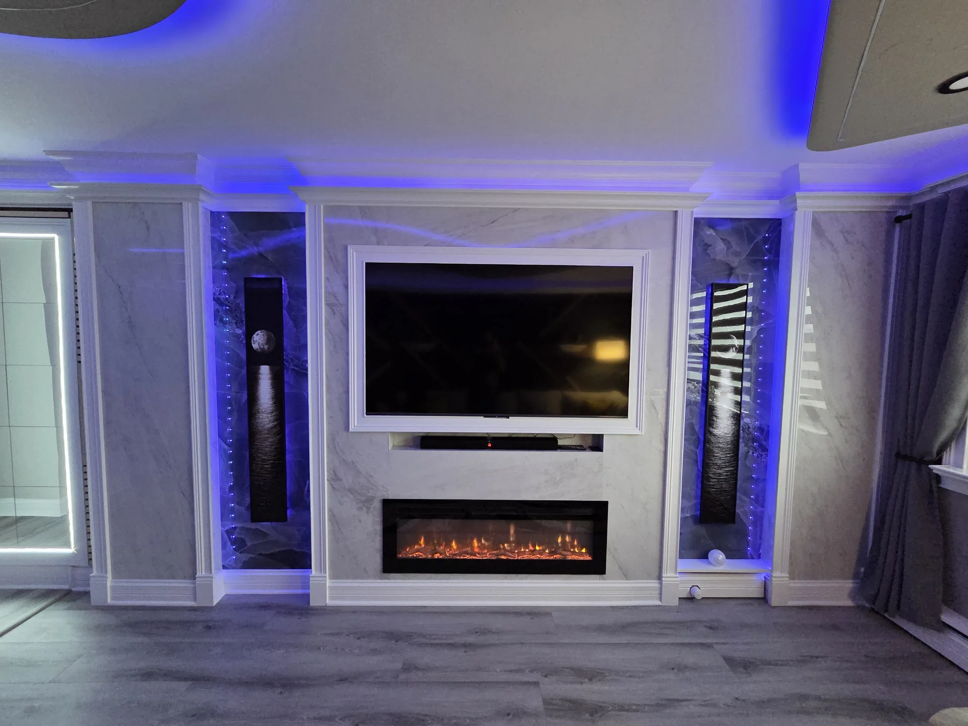 Media wall with electric fireplace and blue LED surround